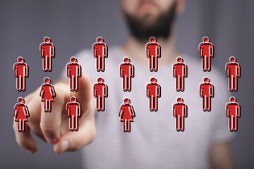 A person's hand touches person icons, symbolizing digital interaction, networking, and a sense of community.