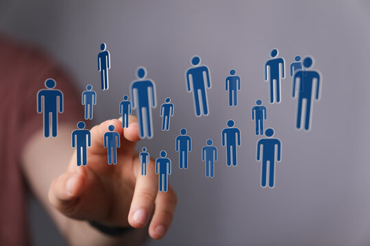Visualize connection with this image of a hand touching digital human icons representing a network of people. Ideal for social media and technol - Powered by Adobe
