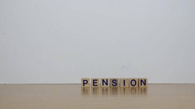 Word pension composed of wooden blocks, on the table rolls a clock.