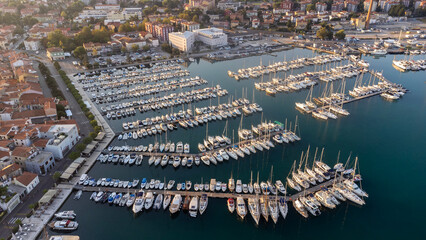 Aerial view of the harbor in the old town of Koper, Slovenia. Drone view of small boats moored in the harbor at dawn on the Istrian coast