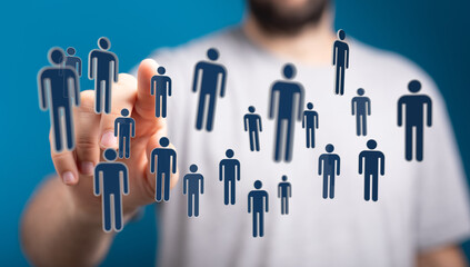 Hand reaching towards 3D rendered human icons, representing social media, network, and communication in digital