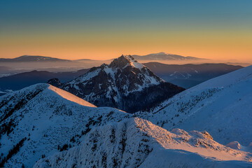 view at Velky Rozsutec in Mala Fatra on snowy slopes during sunrise