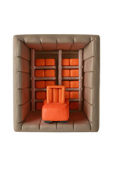Orange chair in cozy padded room with shelves holding orange cushions, creating warm and inviting atmosphere