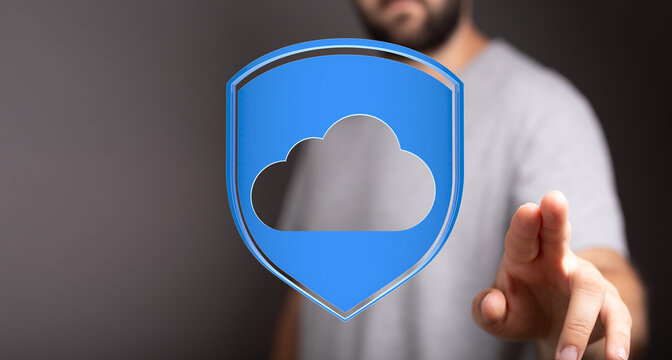 Man touching cloud shield, symbolizing data protection, network security and digital technology. Cloud computin