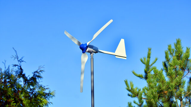 Wind turbine on blue sky. Concept of clean energy. Green technology for future. 