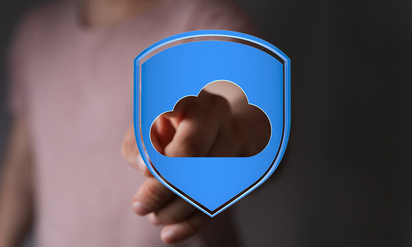 A person pointing to a cloud icon within a shield representing cloud security and future data protection. Illus