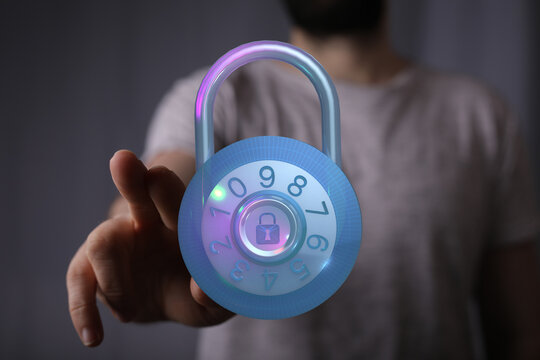 Abstract image showing a hand reaching for a glowing padlock, concept for security, access, protection and privacy in digital world. - Powered by Adobe