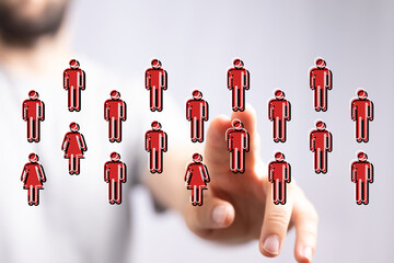 Concept of social networking, team collaboration and business connection. Hand selecting people icons. Representing unity, diversity, and commun