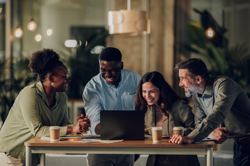 Diverse startup team collaborating and laughing together