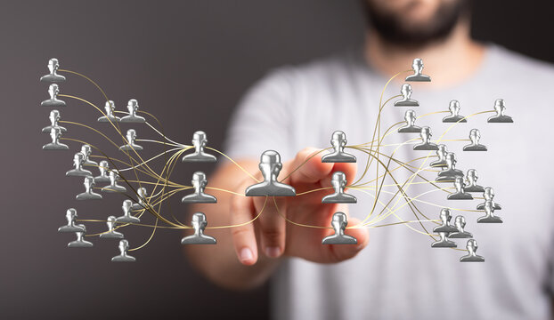 Abstract network of people connection concept in digital age. Hand touches digital icons, representing connection and communication in business