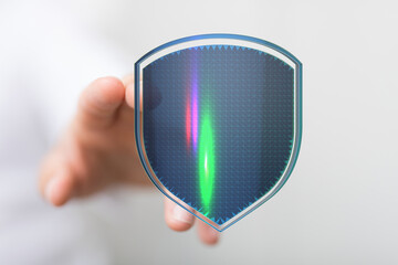 Hand holding a digital shield representing security, data protection, cybersecurity, privacy. This...