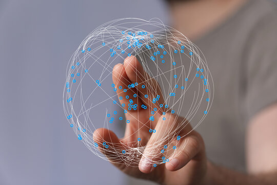 Abstract image of a person interacting with a digital sphere, representing the concept of global connections, the internet, and data
