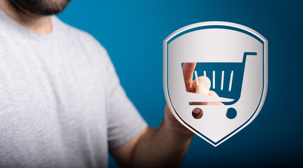 Concept of secure online shopping. Hand holding a shield with shopping cart icon. Representing...