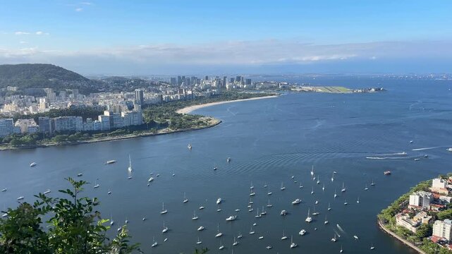 Panoramic view of Rio de Janeiro , showing Flamengo Beach, Aterro do Flamengo, Guanabara Bay, Santos Dumont Airport, Botafogo, Urca,  under partly cloudy sky.