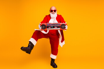 Santa with a retro boombox in a bright yellow studio delivering festive christmas vibe for holiday season promotion