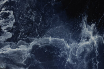 Marble is blue. Light streaks on a marble background. The background is made of blue marble. Granite marble.