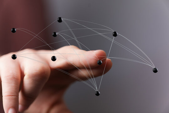 Concept image of a hand interacting with a network of interconnected points, symbolizing concepts like networki