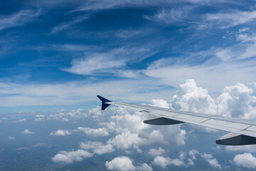 Fototapeta premium flying and traveling, view from airplane window on the wing on sunset time