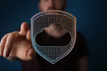 User touching a data protection shield with cloud icon, representing cybersecurity and data safety in digital w
