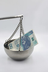 Polish zloty banknotes on balance scale financial concept.