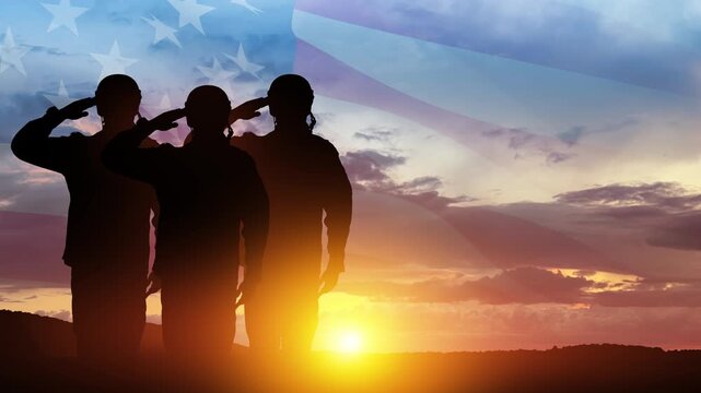 Silhouettes of soldiers saluting on background of sunset or sunrise and USA flag. Veterans Day, Memorial Day, Independence Day. America celebration.