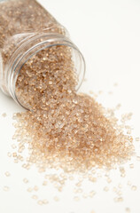 Translucent Polymer Pellets Spilling from Plastic Jar Description: