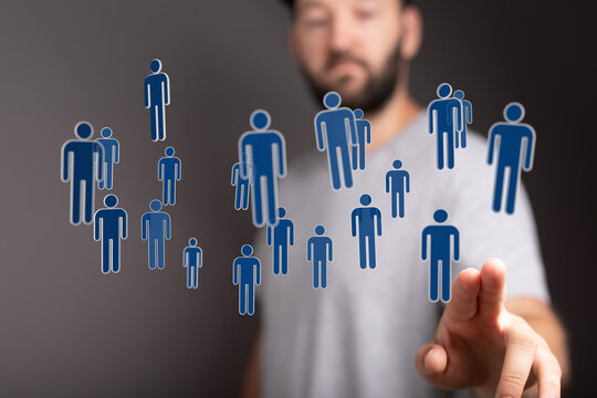 Man touching virtual human icons symbolizing global connections and networking in a business and technological