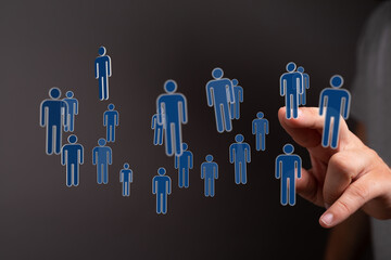 Visual representation of connection, community, and support. A hand interacts with floating human silhouettes.