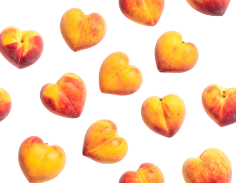 Assortment of fresh, heart-shaped peaches on a dark background. The arrangement is random and playful