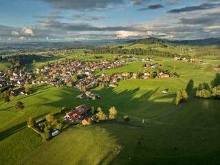 Aerial photo at sunset of the village of Weiler-Simmerberg, district Simmerberg in the western Allgaeu in Bavaria, Germany