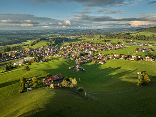 Aerial photo at sunset of the village of Weiler-Simmerberg, district Simmerberg in the western Allgaeu in Bavaria, Germany