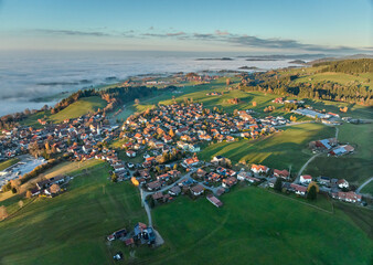 Aerial photo at sunset of the village of Weiler-Simmerberg, district Simmerberg in the western Allgaeu in Bavaria, Germany