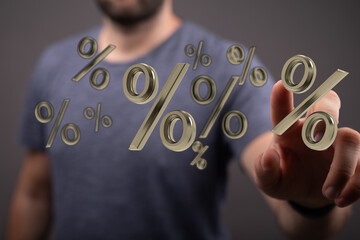 A man's hand interacting with 3D gold percentage signs, illustrating financial growth, investment,...
