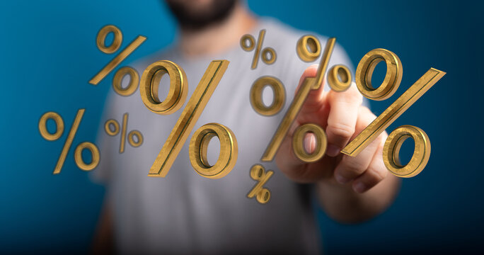 A man's hand interacting with floating golden percentage symbols, representing business, finance, and financial concepts like interest rates and - Powered by Adobe