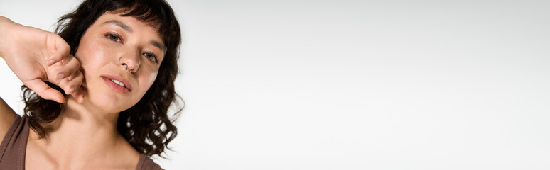 Obraz premium Young woman showcases stylish attire with confidence and grace in a modern setting