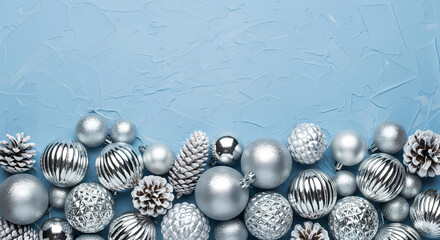 WINTER HOLIDAY BORDER WITH SILVER ORNAMENTS AND FROSTED PINE CONES ON BLUE TEXTURED BACKGROUND