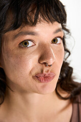 Fototapeta premium Young woman showcases unique style with confidence and charm in a bright setting