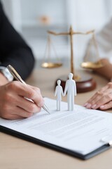 Signing legal documents with miniature figures symbolizing family unity and justice