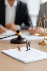 Miniature figures symbolize legal discussions on documents in courtroom setting