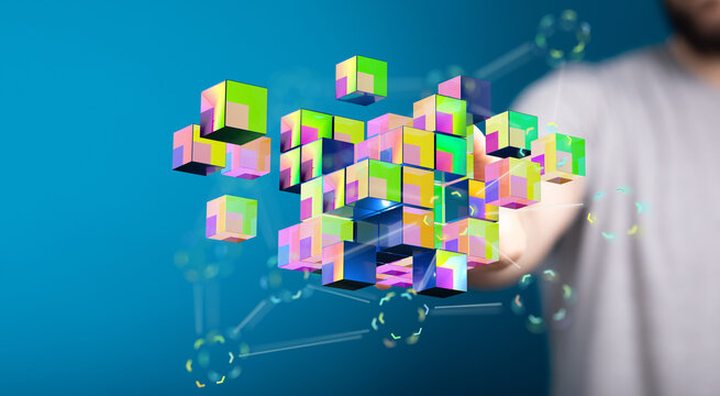 Digitally rendered image showcasing colorful cubes, symbolizing data and connection, linked to a person's hand,