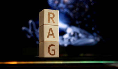 Blocks with the letters RAG are stacked prominently in front of an out-of-focus background filled with colors. This scene suggests themes of technology and creative ideas