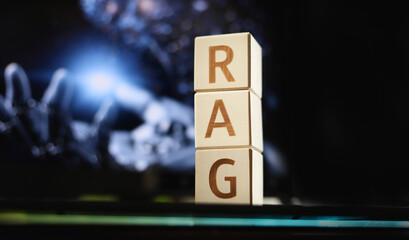 Blocks arranged to show the letters R, A, and G are placed on a surface. The background hints at advanced technology with its soft, glowing lights and mechanical elements