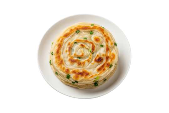 Top view of a golden brown savory scallion pancake on a white plate