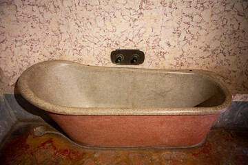 Vintage stone bathtub inside rustic old bathroom creating antique atmosphere with warm colors and classic marble texture perfect for interior inspiration.