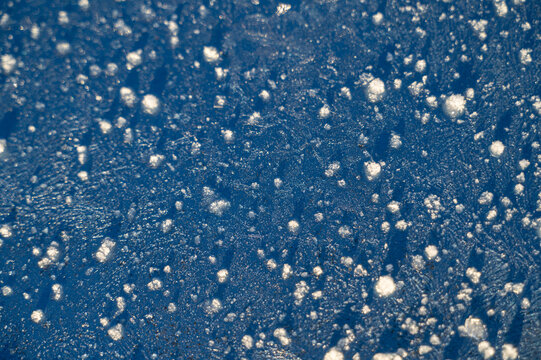 Frozen Ice Surface with Snow Pellets