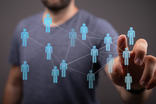 Close-up of a man's hand interacting with a digital network, representing concepts like teamwork, communication