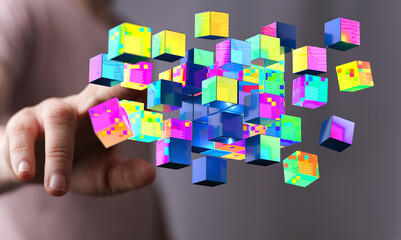 Abstract image showing a hand reaching for vibrant, colorful digital cubes. Modern technology and data concepts