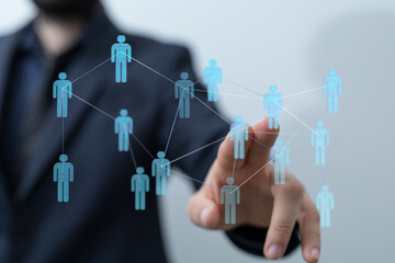 Concept of communication and social interaction. Hand of businessman touching a network of people. Global conne