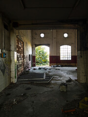 Old abandoned building interior with red walls and graffiti reflecting industrial decline urban exploration and mysterious nostalgic ambiance.