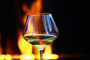 Elegant Wine Glass with Fiery Background for Cozy and Warm Atmosphere